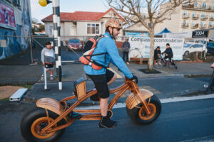 Man riding wooden bike with massive tyres