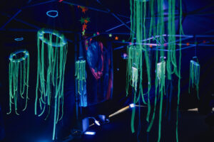 UV room with decorations glowing and hanging from ceiling